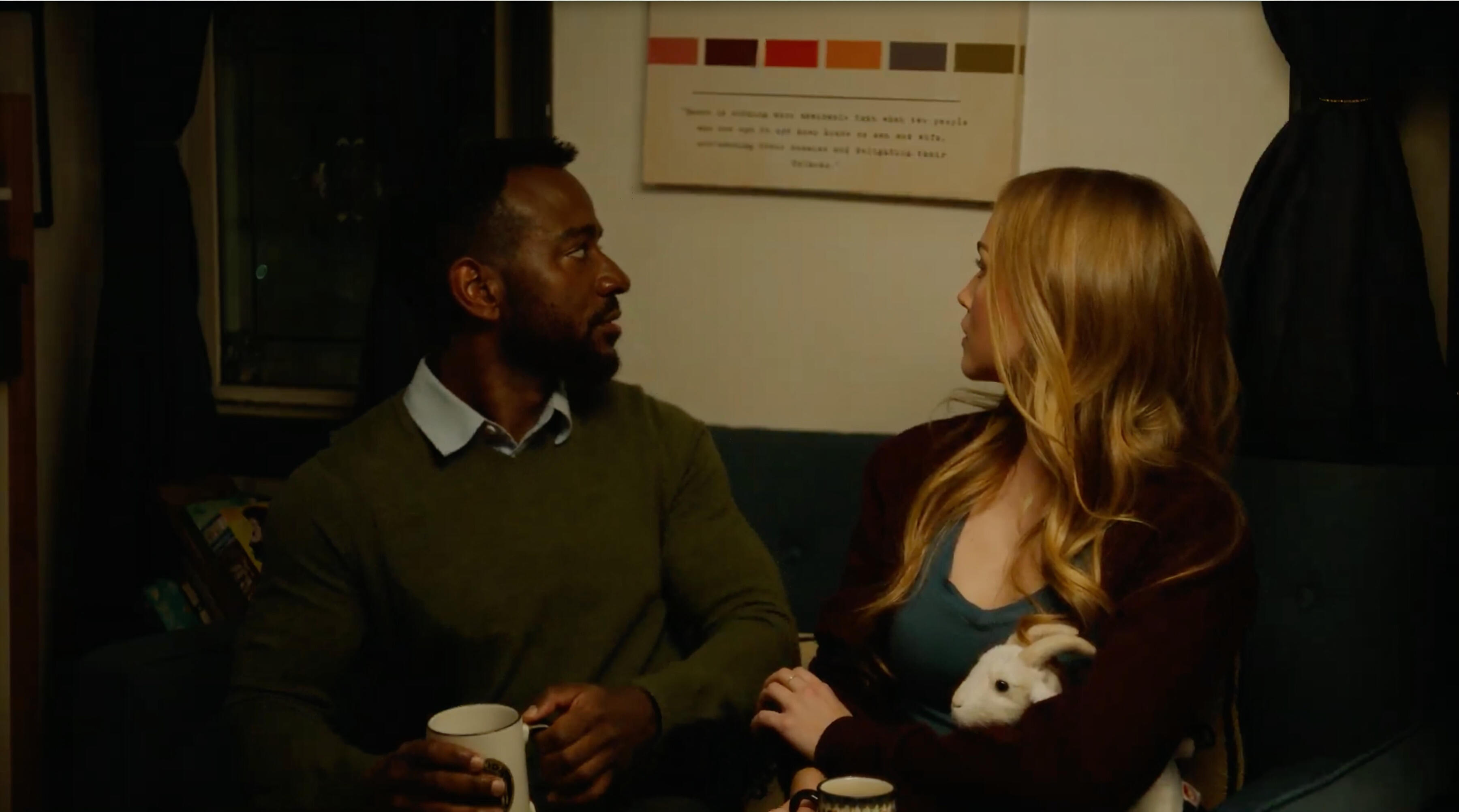 Man and a woman looking back at a quote on a sign.